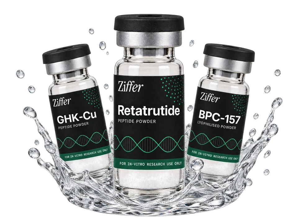 Three overlapping clear glass Ziffer vials with black caps and black labels carrying a drawn green helix and a green band — Retatrutide front and centre, GHK-Cu left, BPC-157 right — standing in a crown splash of crystal-clear water.